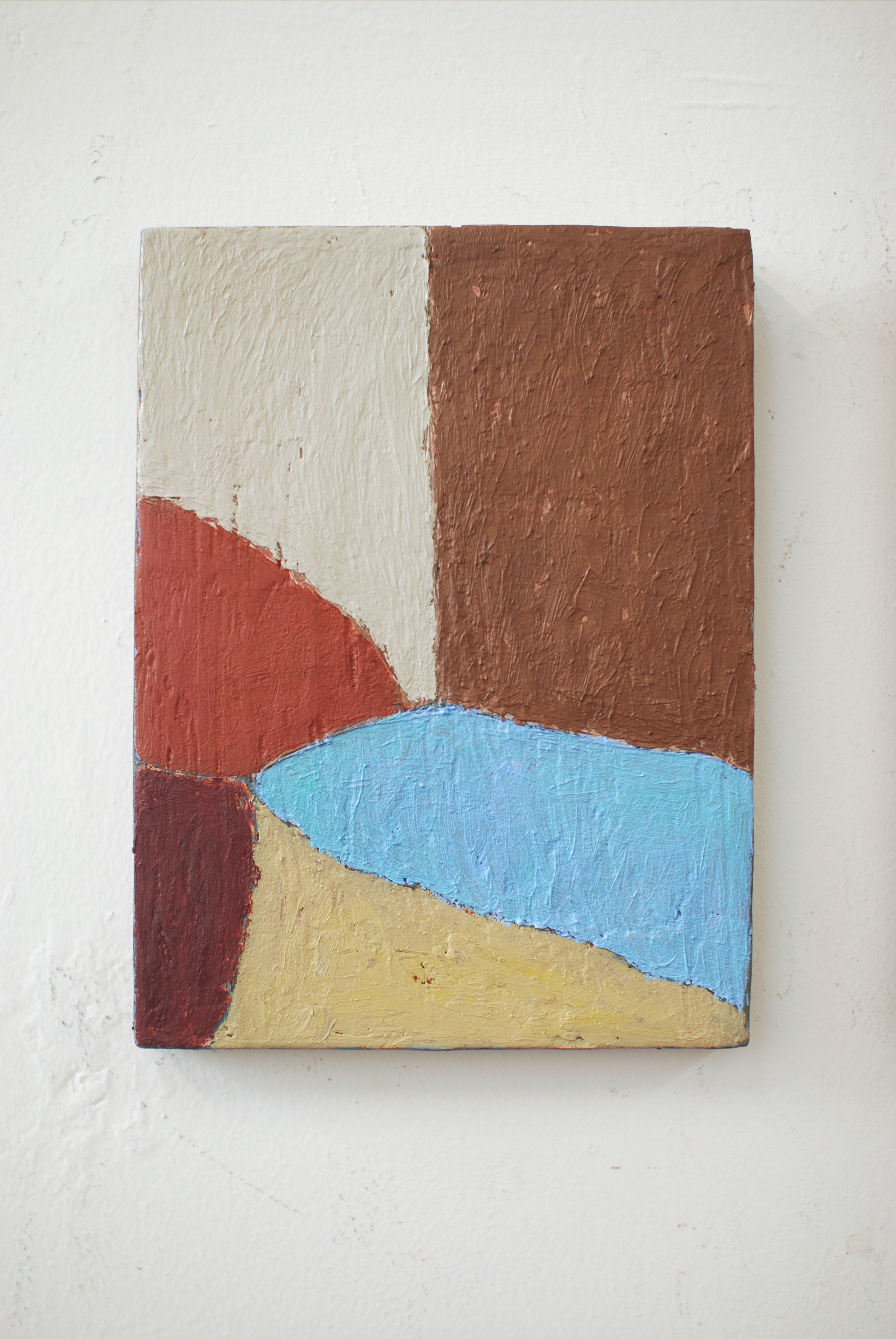 Abstract painting with geometric shapes on a white wall