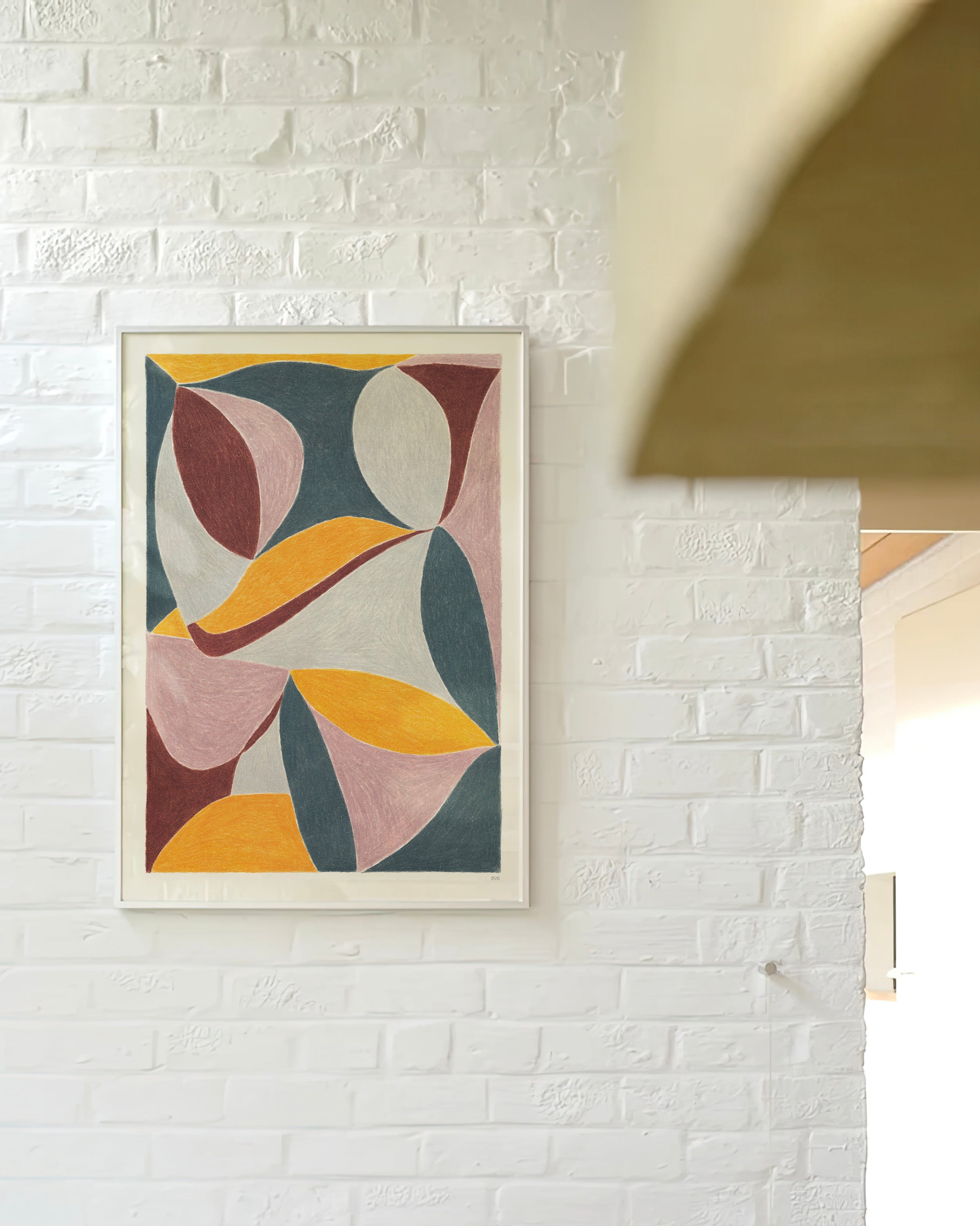 An original art print framed in white timber. Hanging on a white brick wall in a living area. Featuring contrasting colours and flowing shapes. Dark grey, light cool grey, burgundy, mauve, and golden yellow.